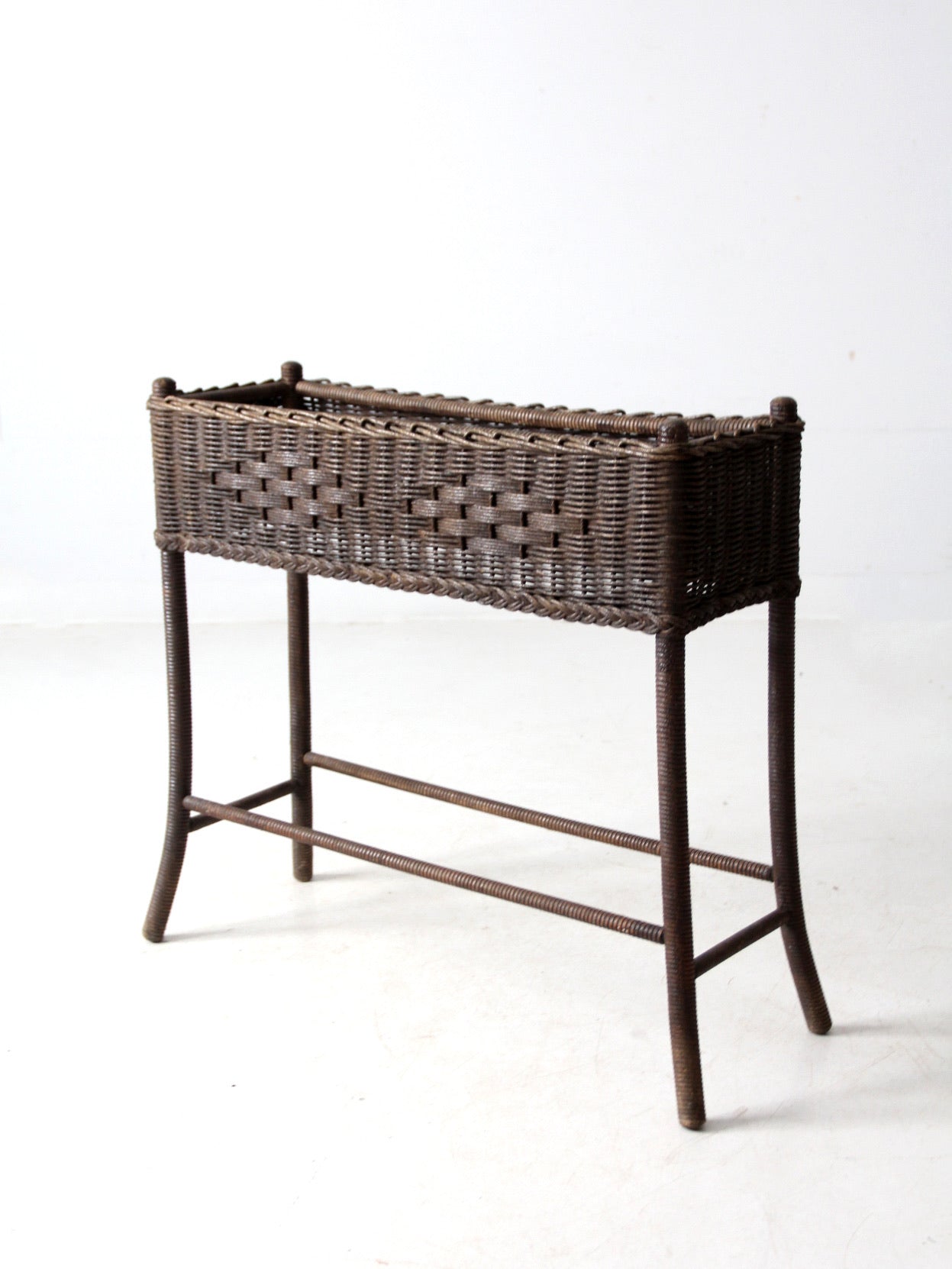antique woven wicker planter stand