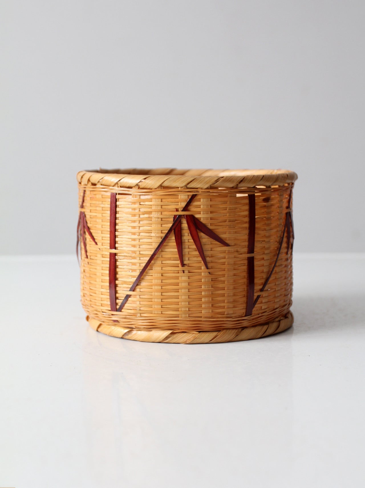 vintage woven basket with bamboo motif