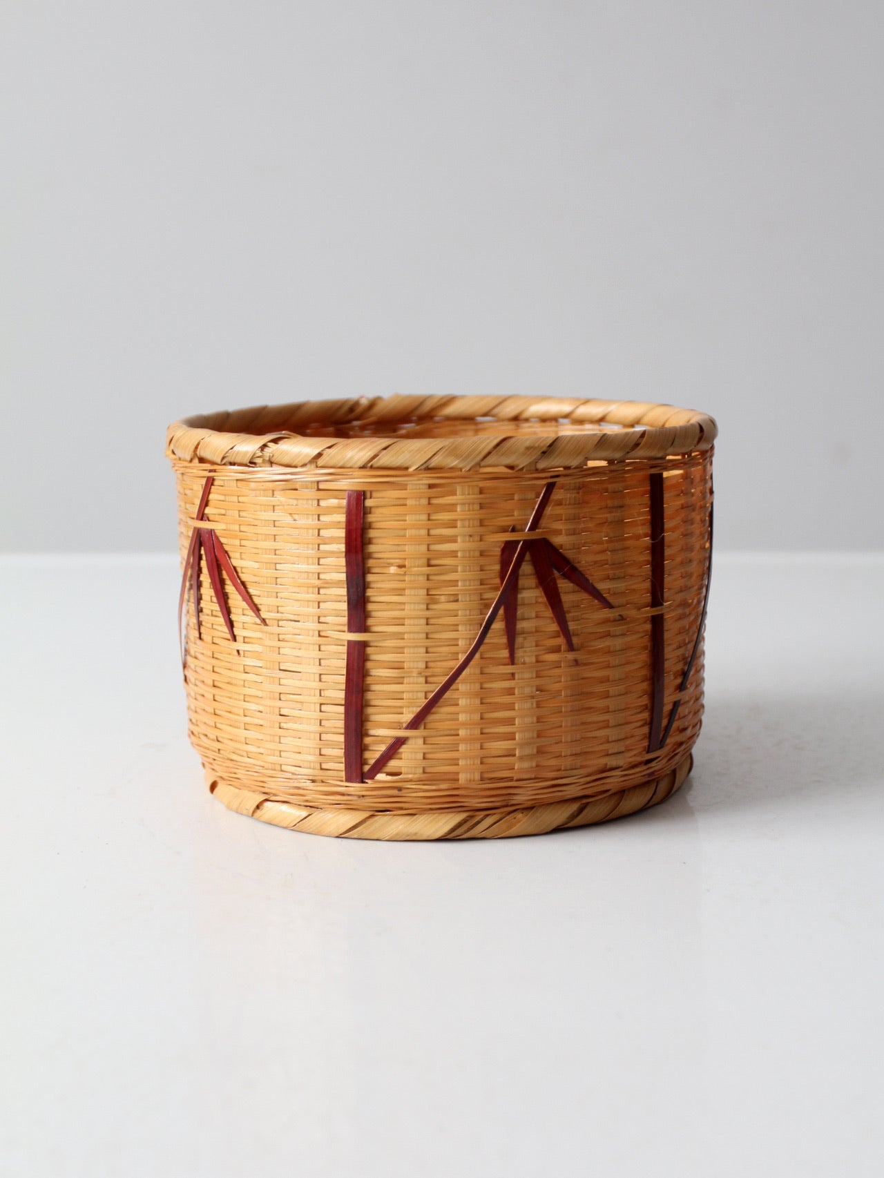 vintage woven basket with bamboo motif