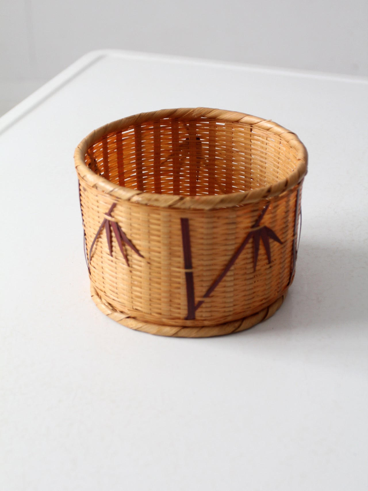 vintage woven basket with bamboo motif