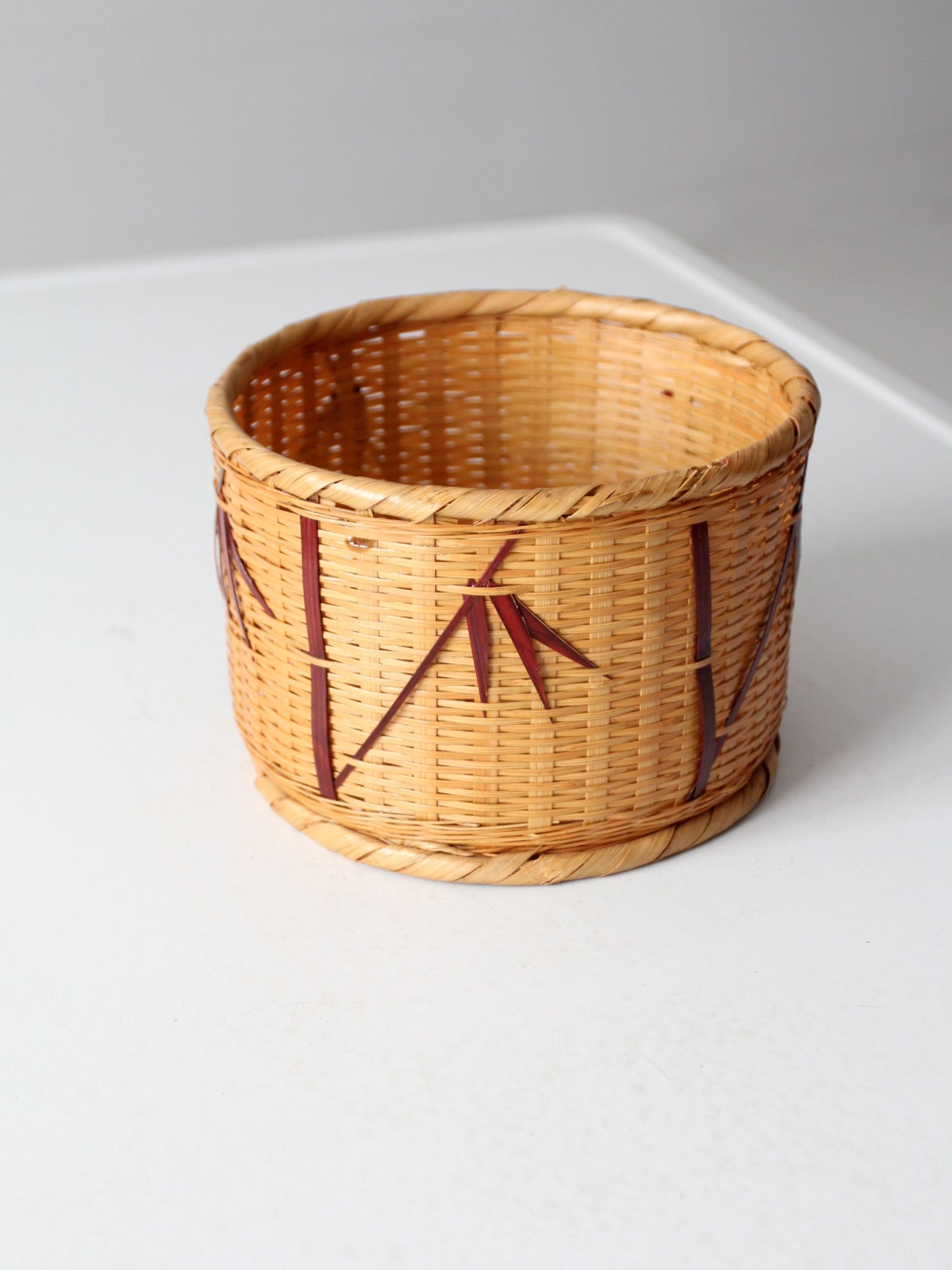 vintage woven basket with bamboo motif