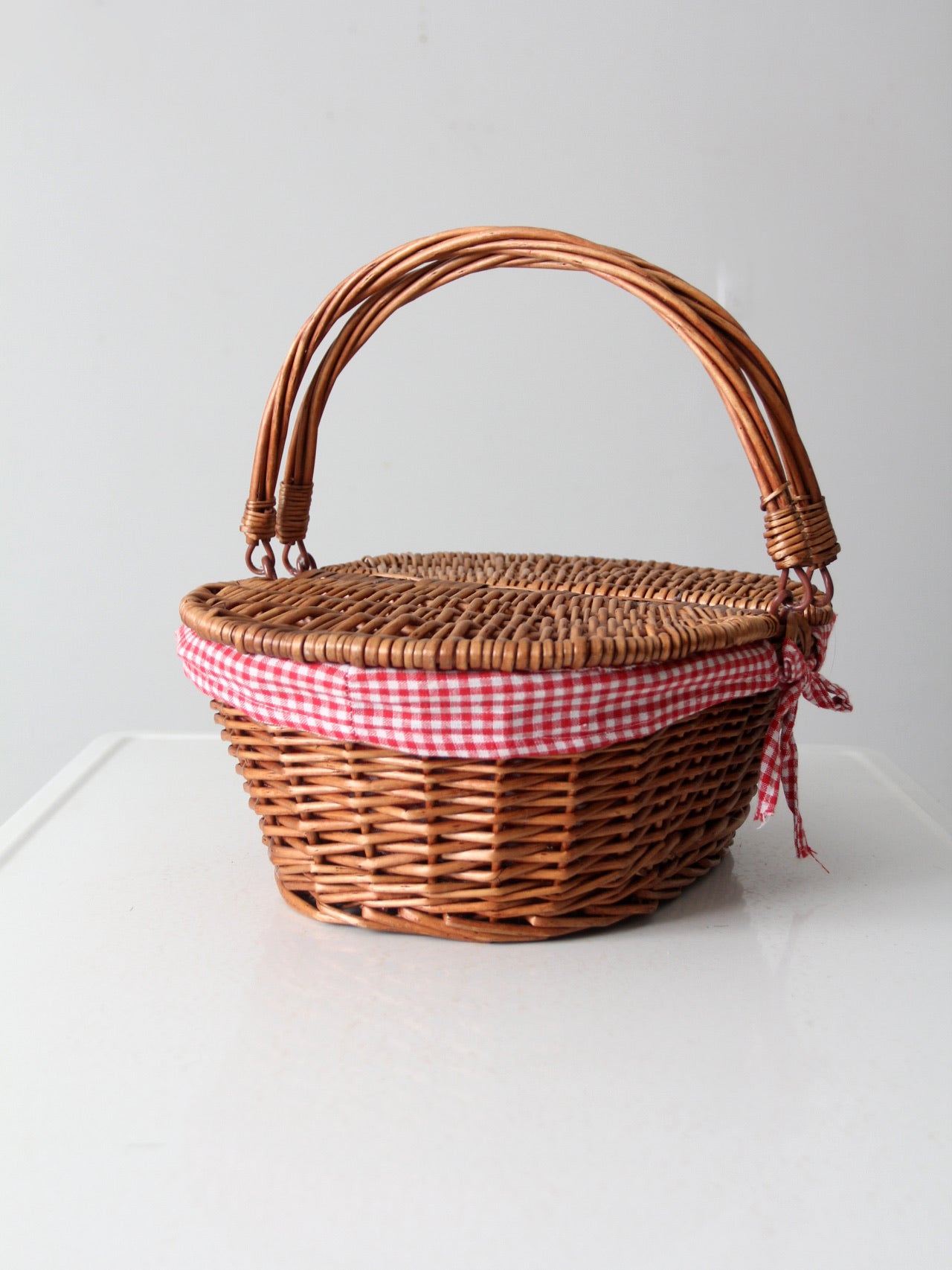 vintage wicker picnic basket with gingham lining