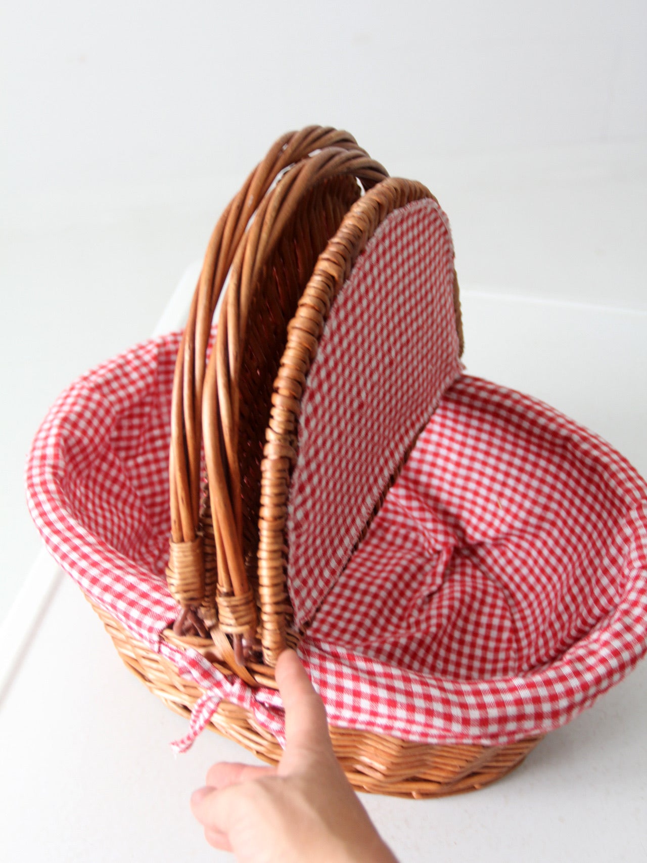 vintage wicker picnic basket with gingham lining