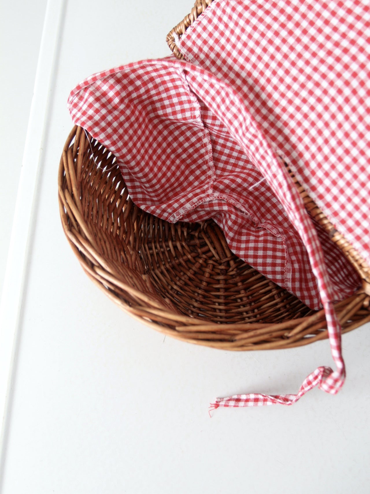 vintage wicker picnic basket with gingham lining
