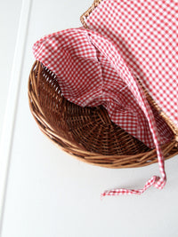 vintage wicker picnic basket with gingham lining