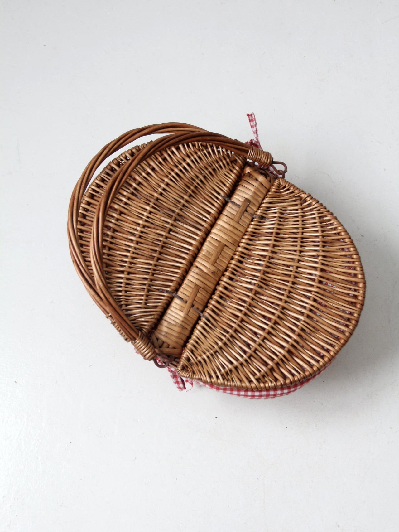 vintage wicker picnic basket with gingham lining
