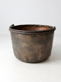 antique copper pot with iron handle