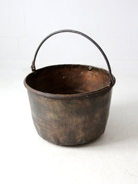 antique copper pot with iron handle