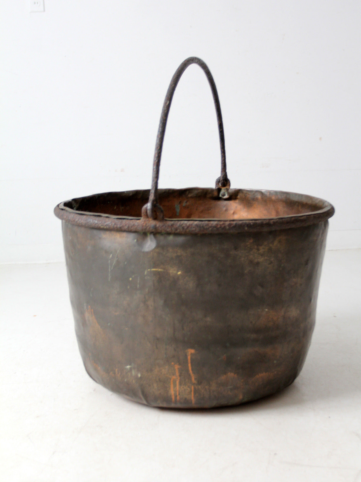 antique copper pot with iron handle