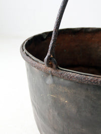antique copper pot with iron handle