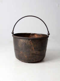 antique copper pot with iron handle