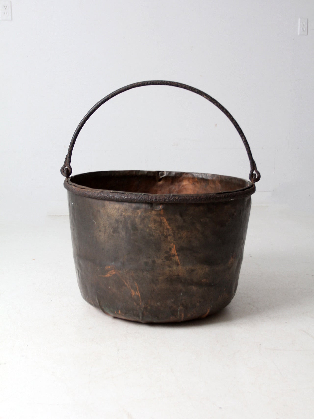 antique copper pot with iron handle