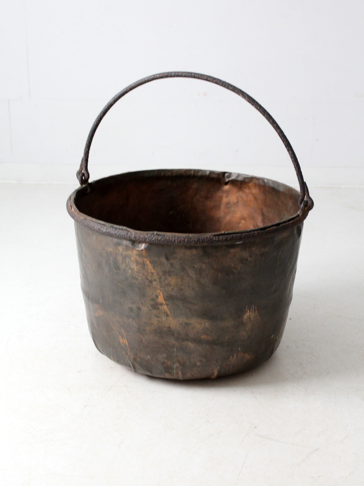 antique copper pot with iron handle