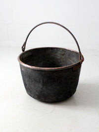 antique copper pot with iron handle