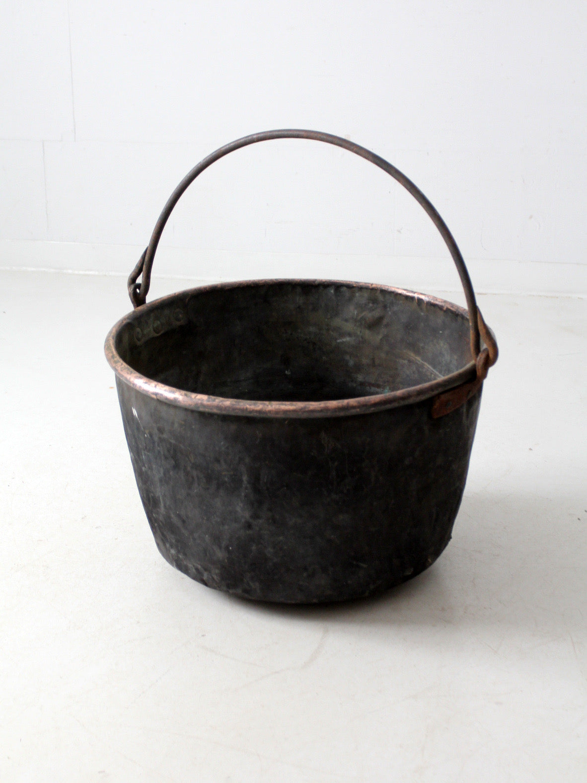 antique copper pot with iron handle