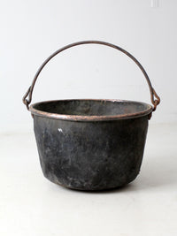 antique copper pot with iron handle