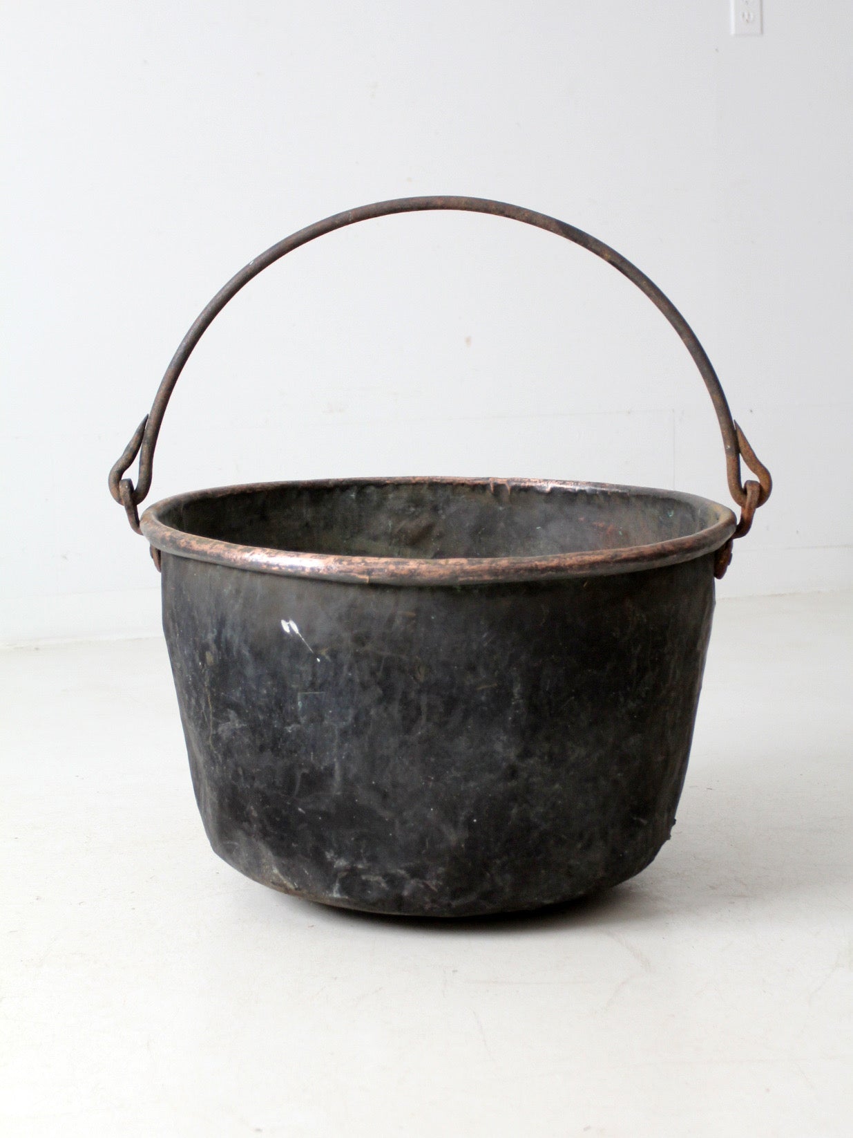 antique copper pot with iron handle