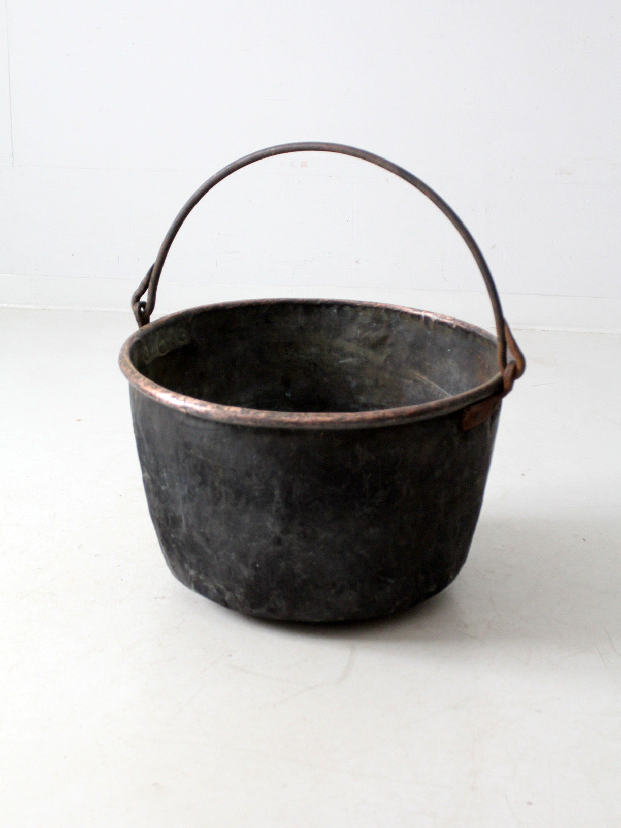 antique copper pot with iron handle