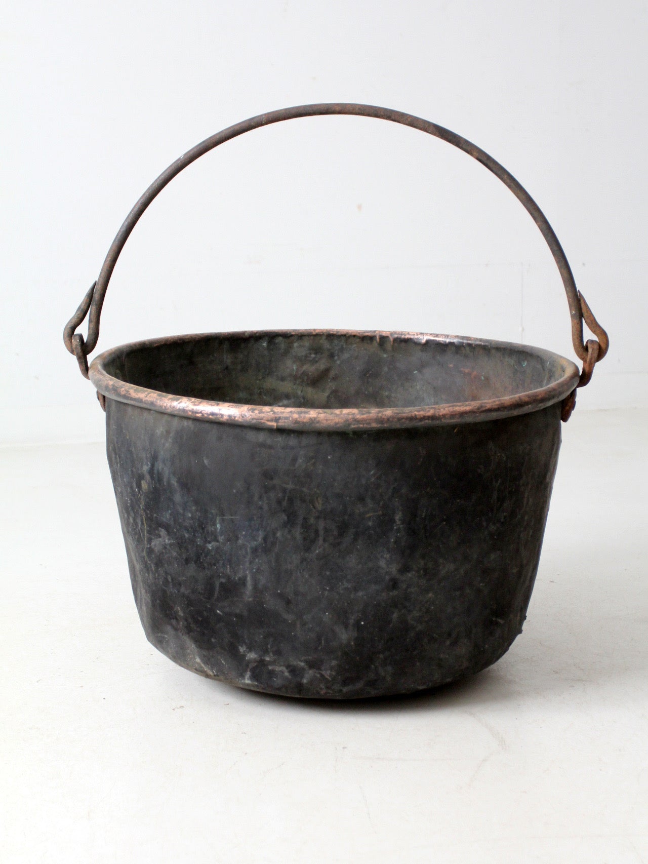 antique copper pot with iron handle