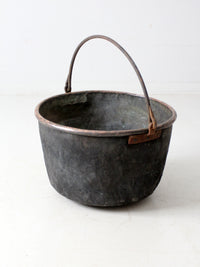 antique copper pot with iron handle