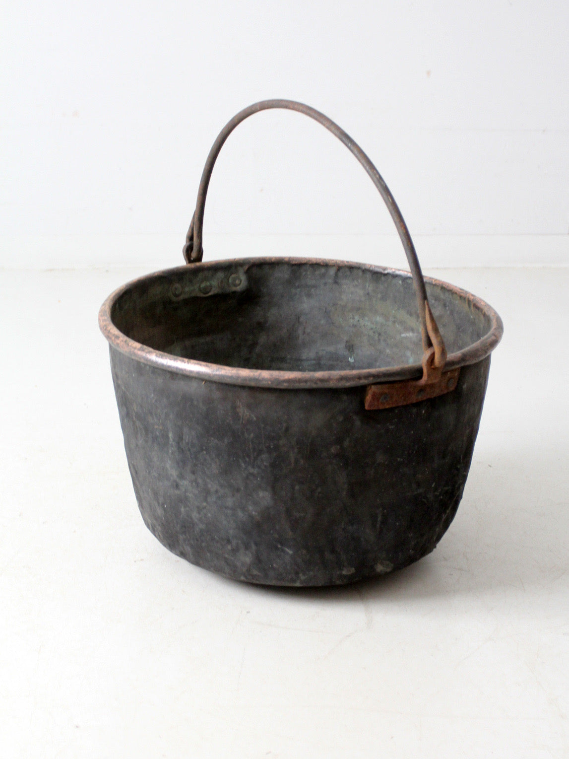 antique copper pot with iron handle