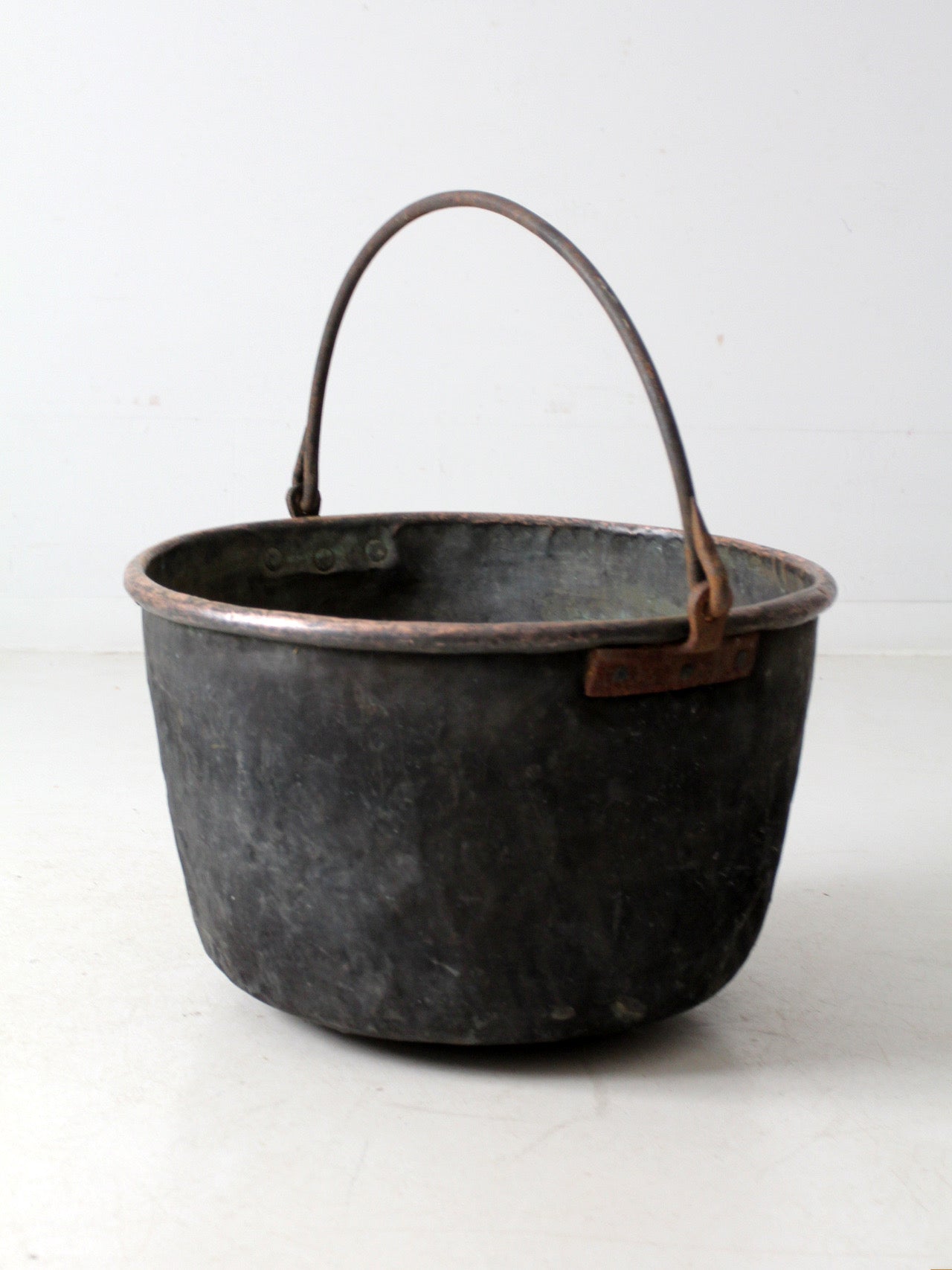 antique copper pot with iron handle