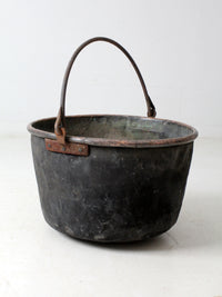 antique copper pot with iron handle