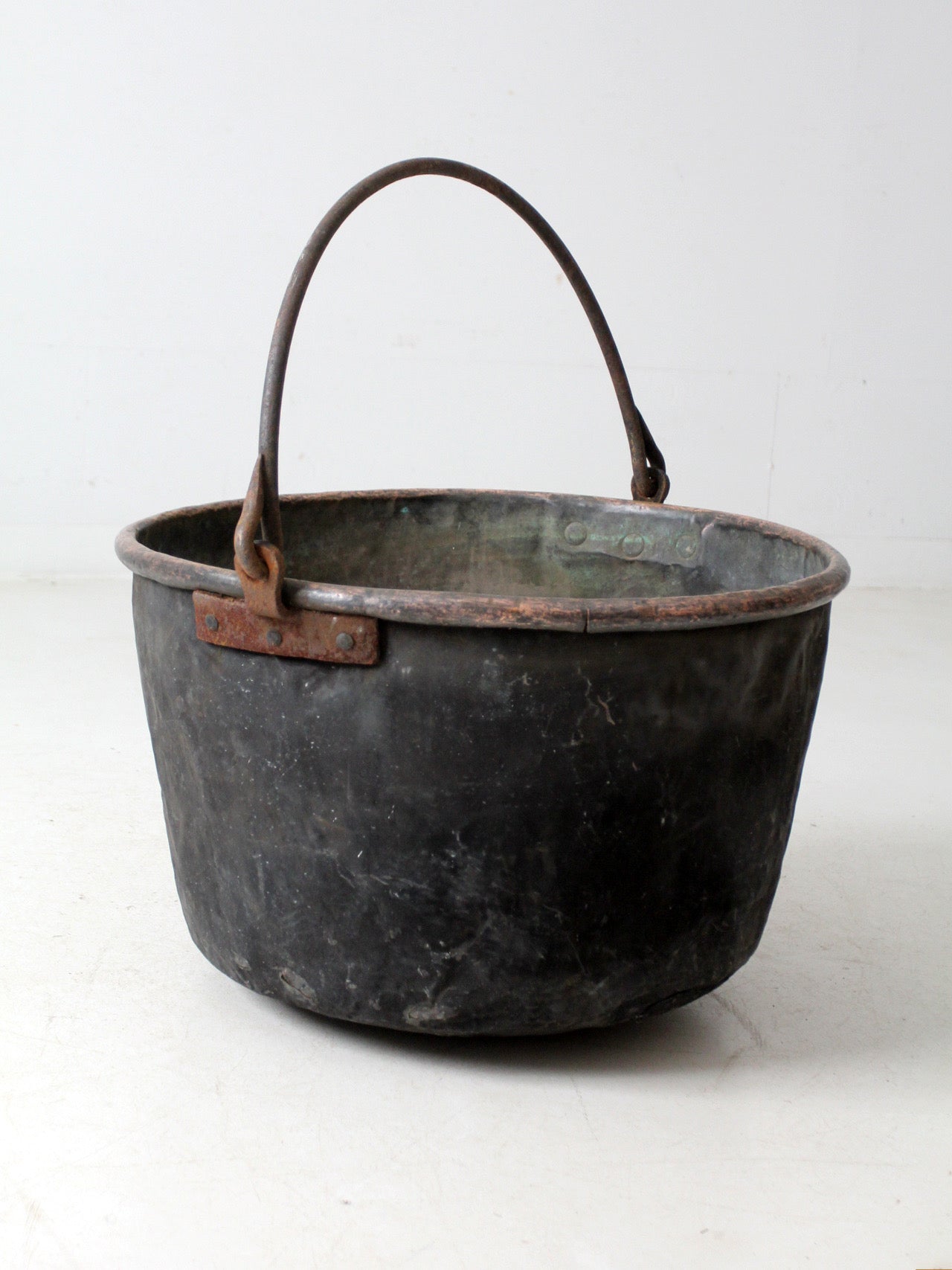 antique copper pot with iron handle