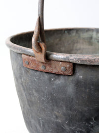 antique copper pot with iron handle