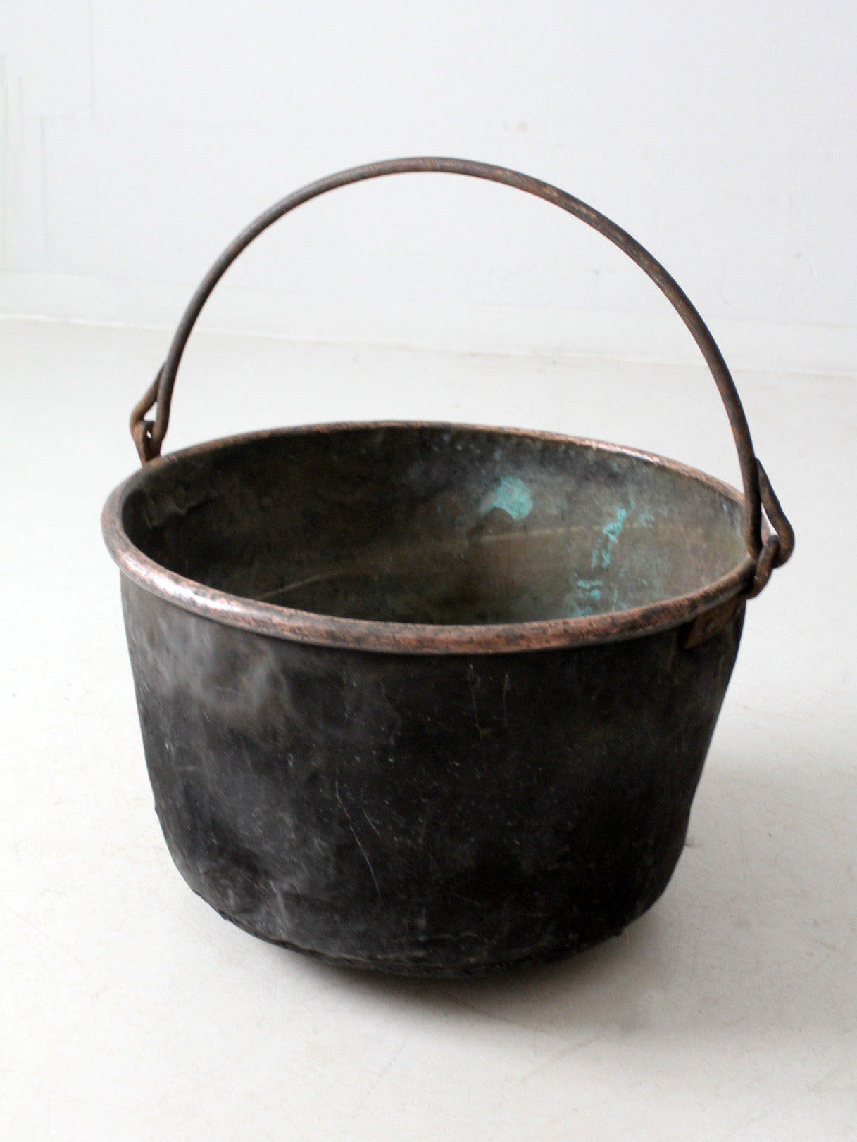 antique copper pot with iron handle