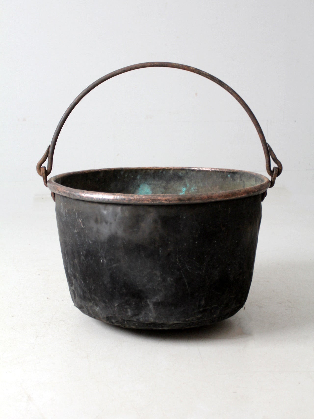 antique copper pot with iron handle