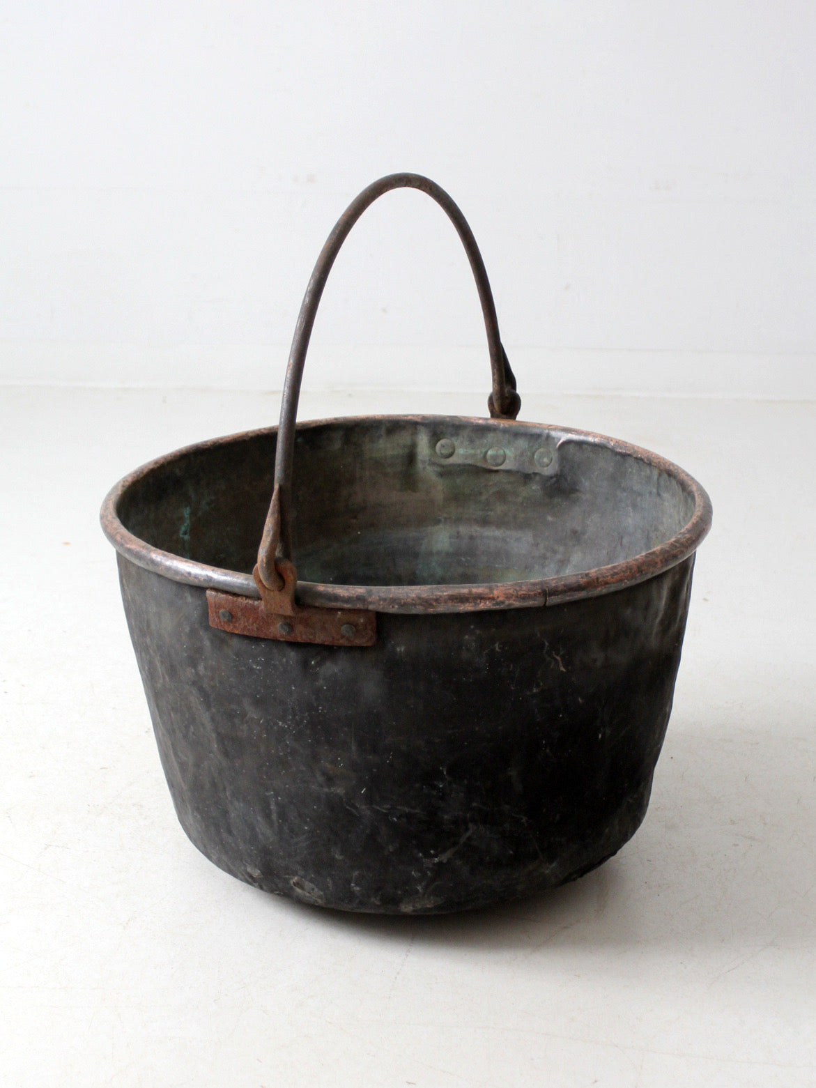 antique copper pot with iron handle