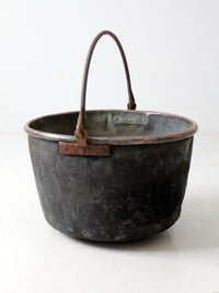 antique copper pot with iron handle