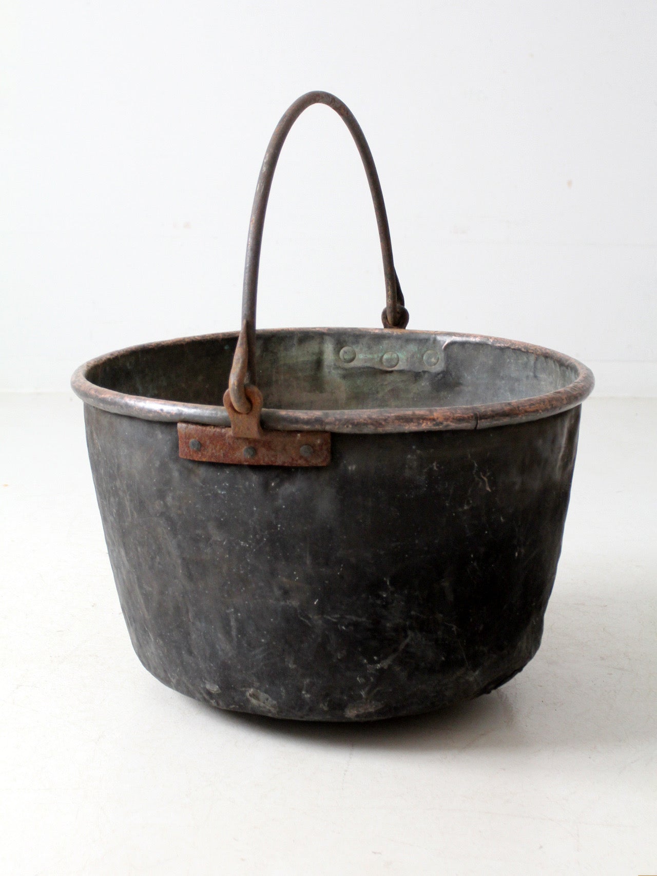 antique copper pot with iron handle