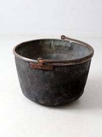 antique copper pot with iron handle