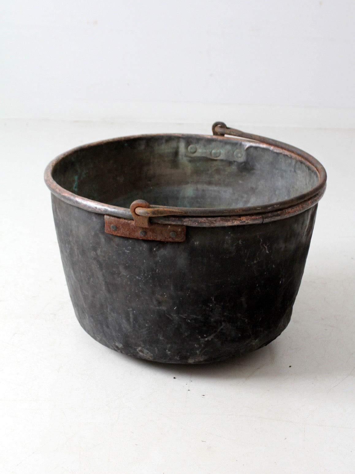 antique copper pot with iron handle