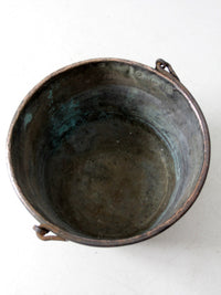 antique copper pot with iron handle