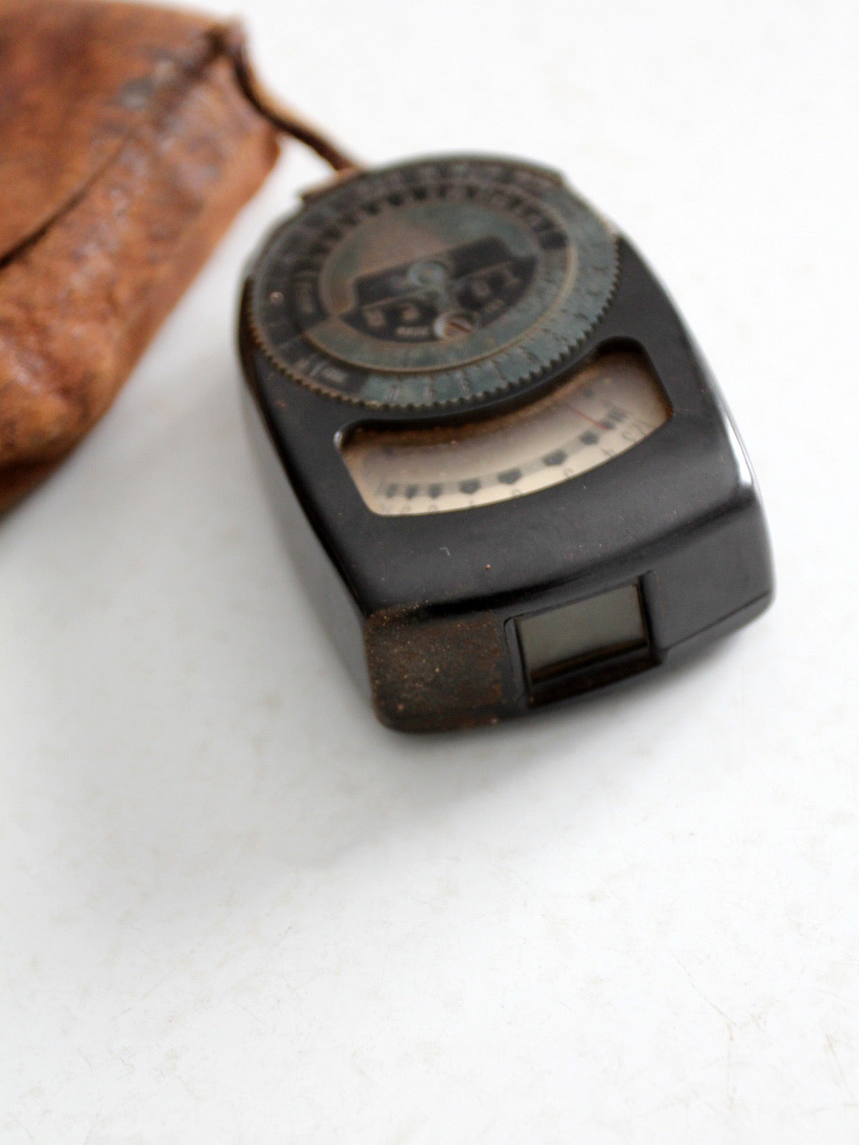 vintage Tower brand gauge with leather pouch