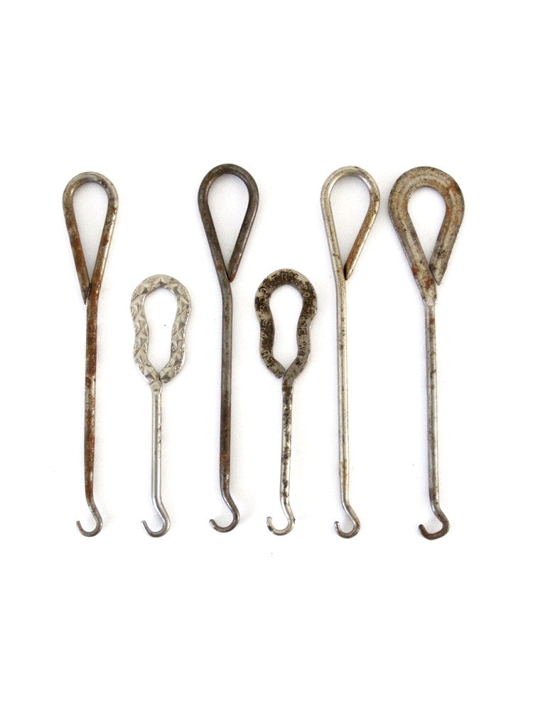Antique buttonhooks and shoehorns. A buttonhook is a tool used to