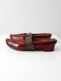 antique carved wood clogs