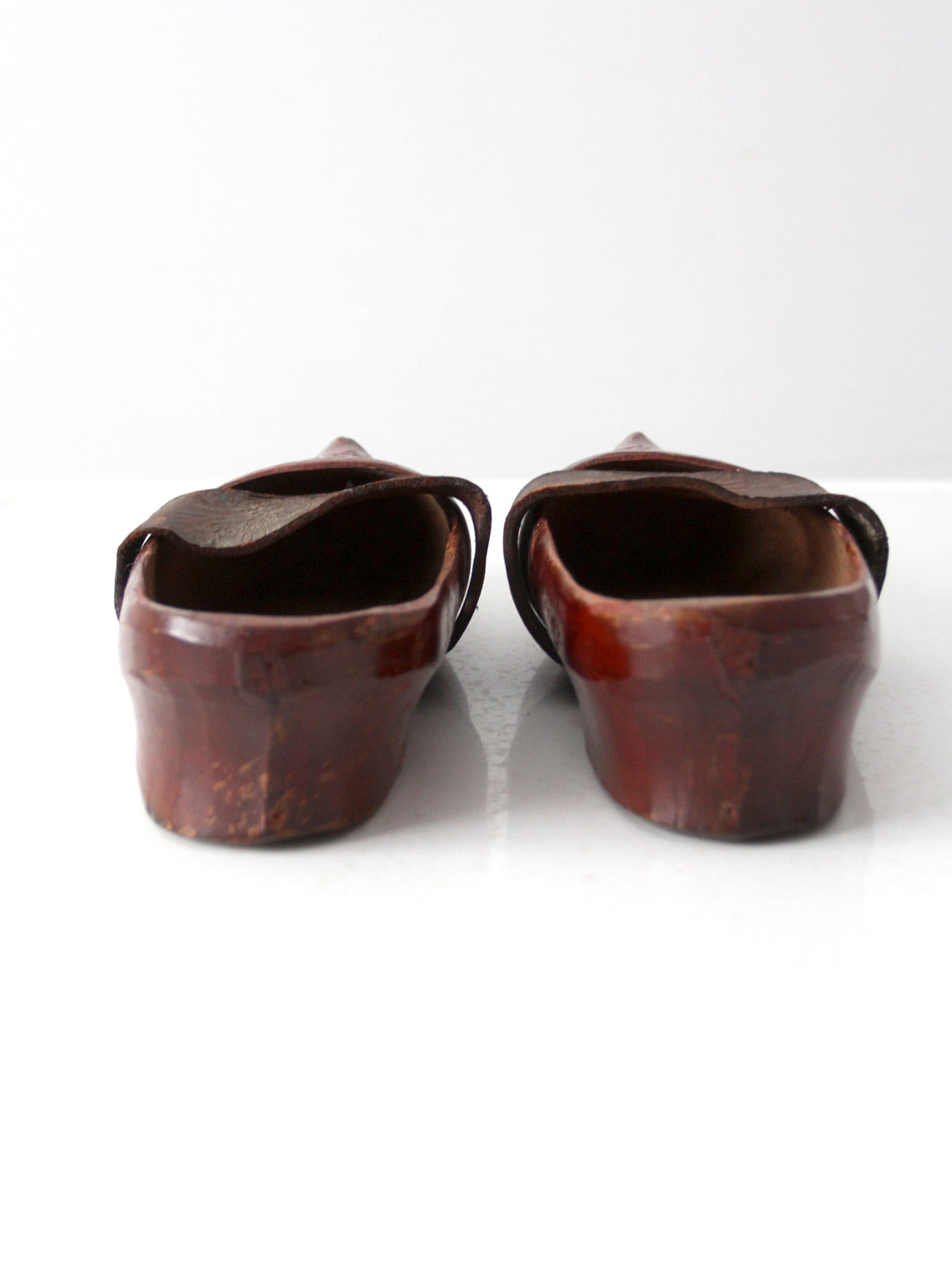 antique carved wood clogs