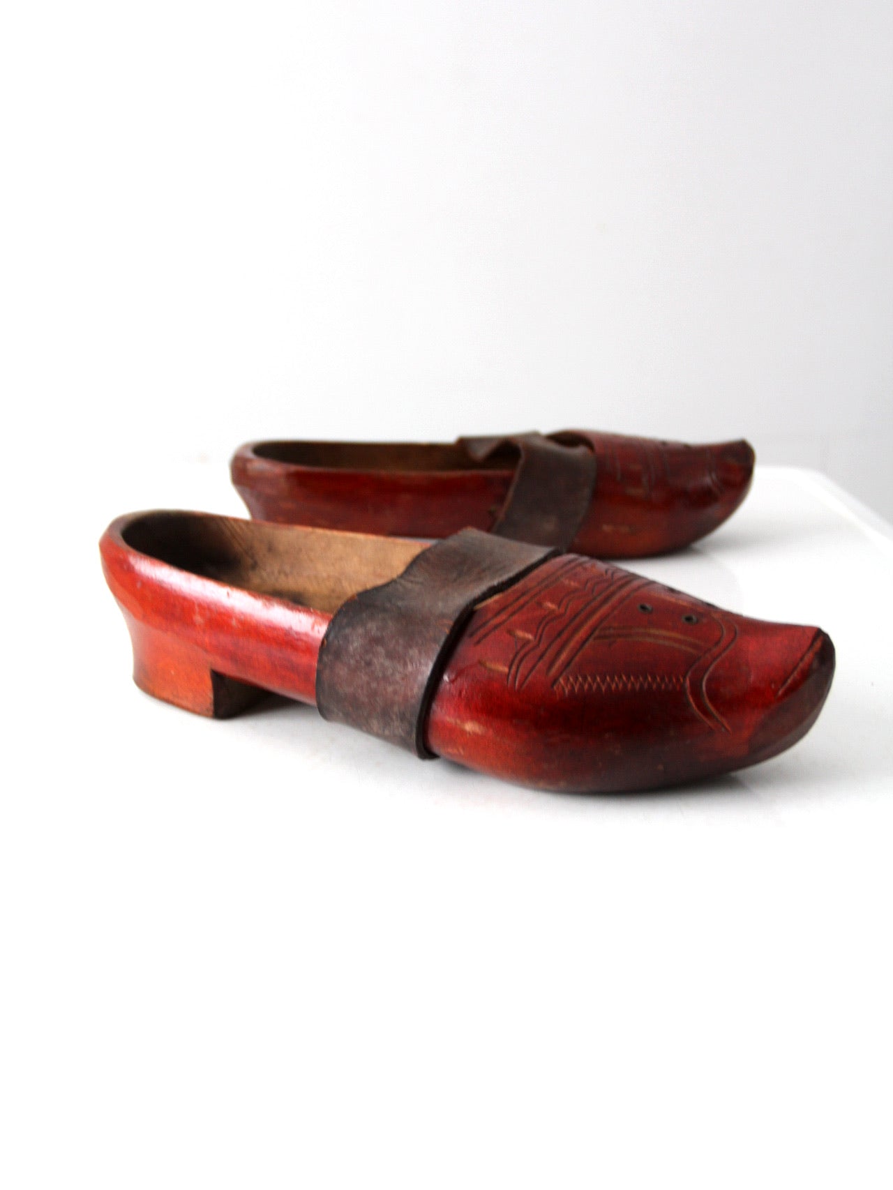 antique carved wood clogs
