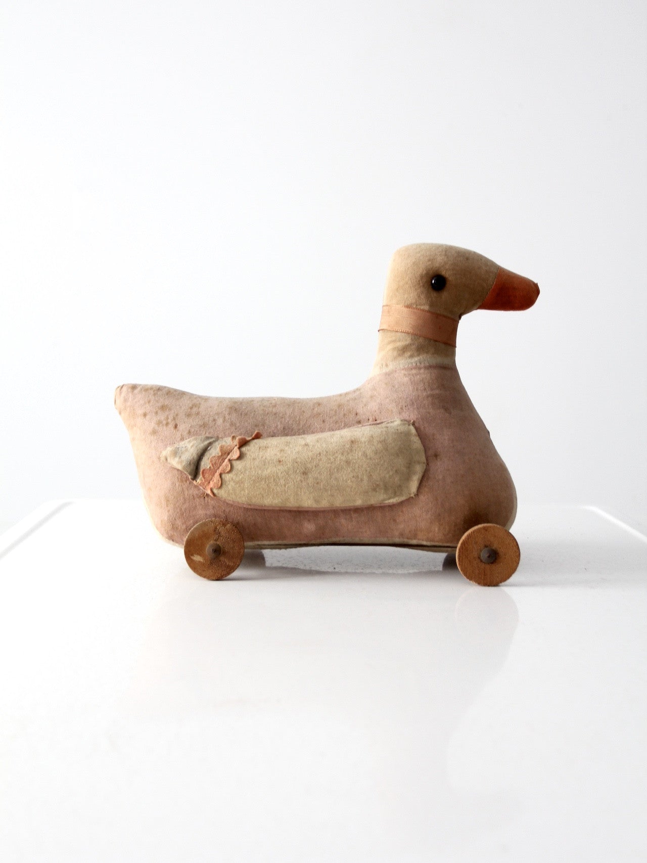 antique toy duck on wheels