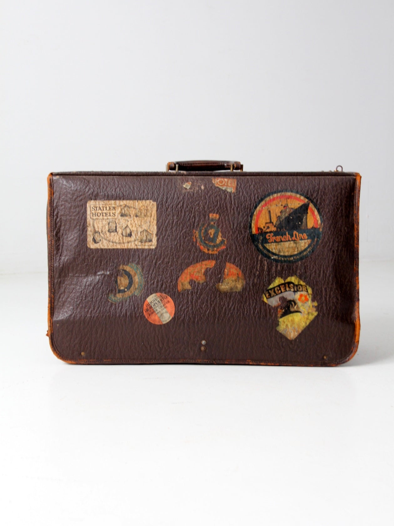 vintage leather suitcase with travel stickers