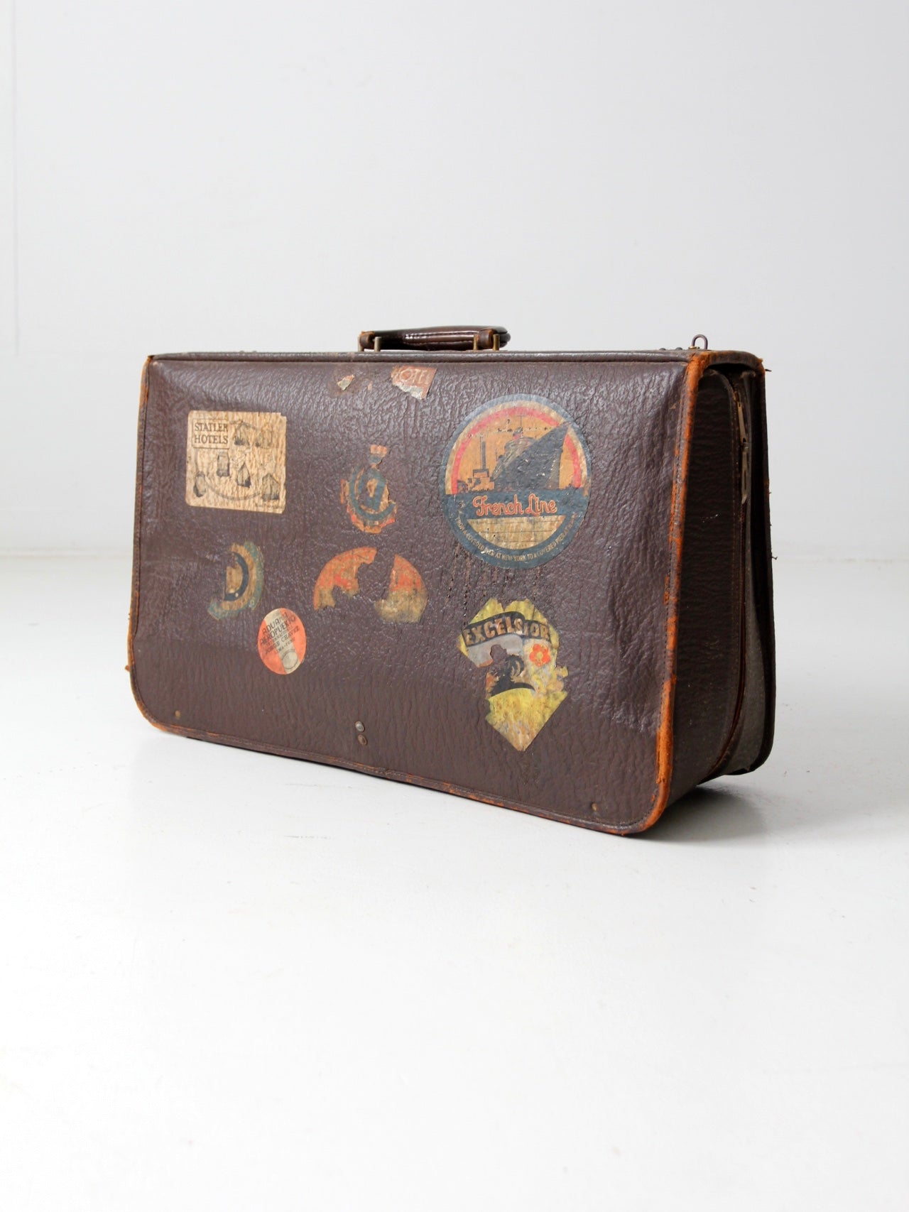 vintage leather suitcase with travel stickers