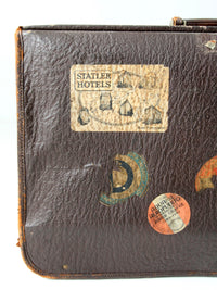 vintage leather suitcase with travel stickers
