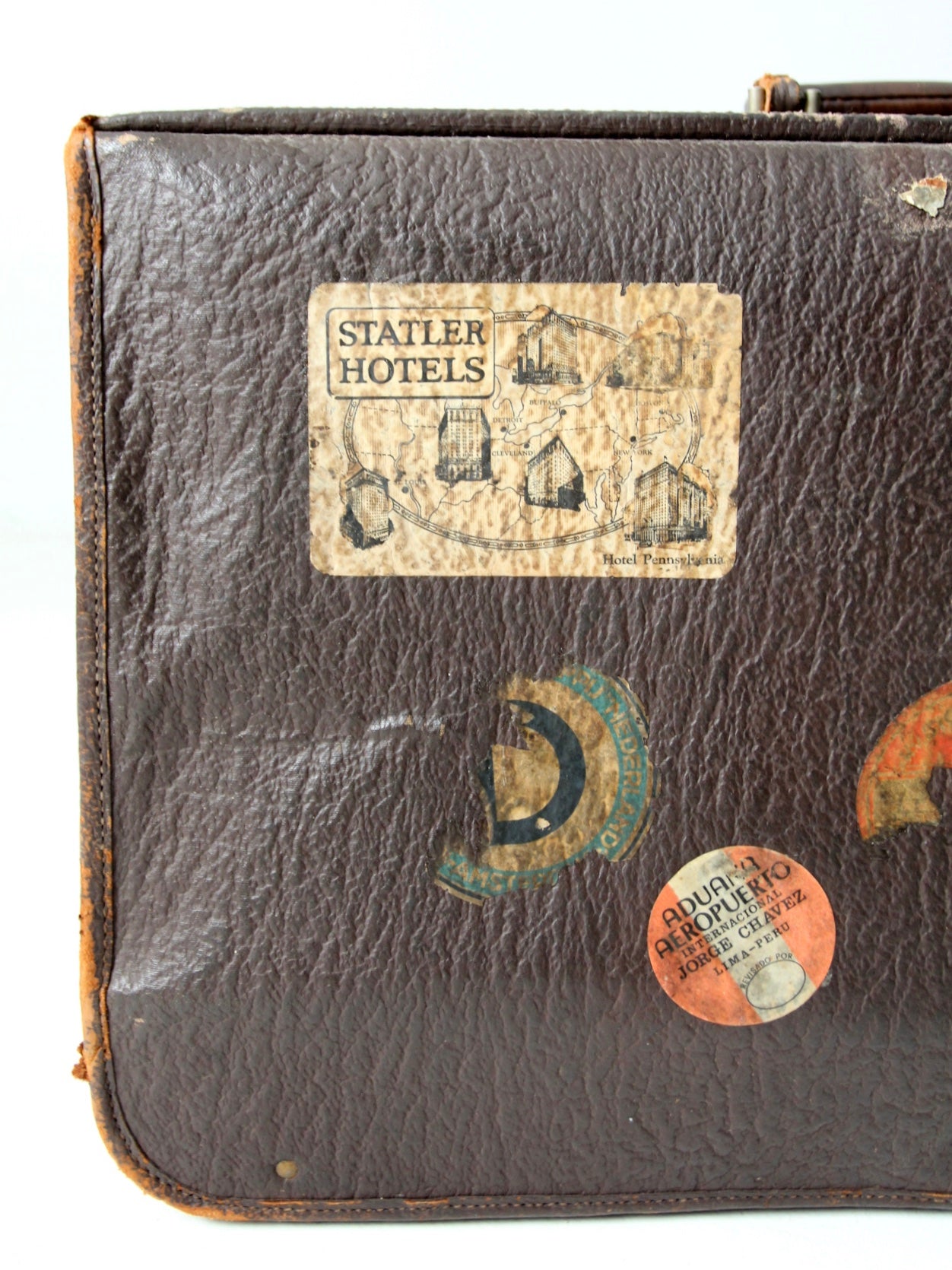 vintage leather suitcase with travel stickers
