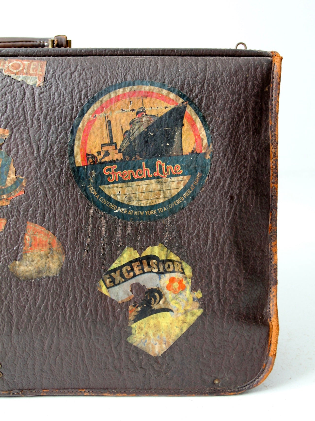 vintage leather suitcase with travel stickers