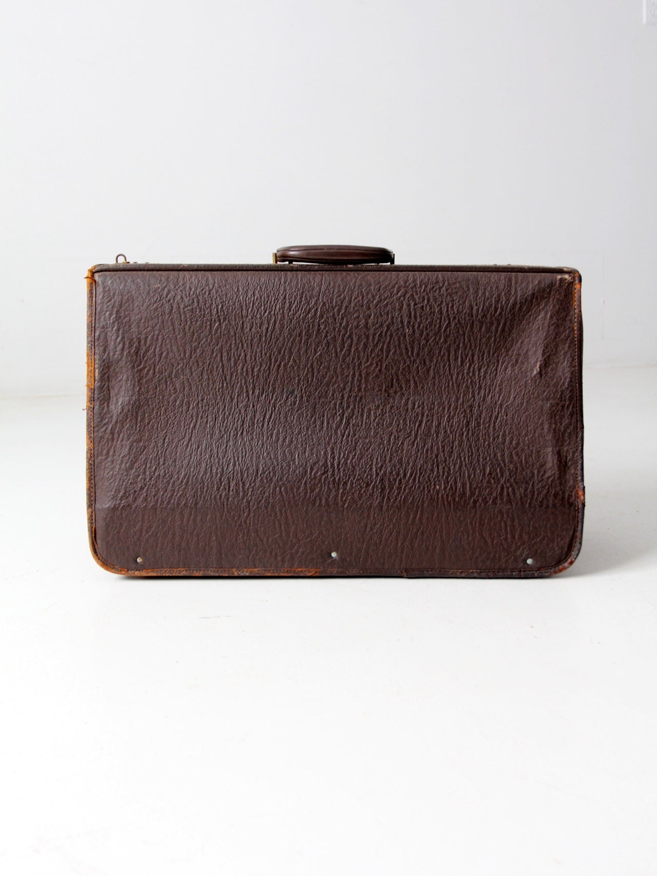 vintage leather suitcase with travel stickers