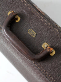 vintage leather suitcase with travel stickers